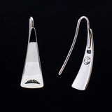 Front and back views of triangle-shaped sterling silver earrings stamped with sunrays from Capulin Creations