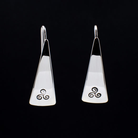 Front view of triangle-shaped sterling silver earrings stamped with triple spiral from Capulin Creations