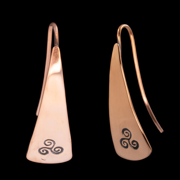 Front and side views of triangle-shaped copper earrings stamped with triple spiral from Capulin Creations
