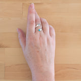 Hand of woman wearing the Turquoise and Sterling Silver Adjustable Ring with One Stone