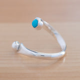 Side view of the Turquoise and Sterling Silver Adjustable Ring with One Stone and One Granule