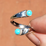 Hand of woman holding the Turquoise and Sterling Silver Adjustable Ring with Two Stones