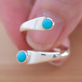 Hand of woman holding the Turquoise and Sterling Silver Adjustable Ring with Two Stones
