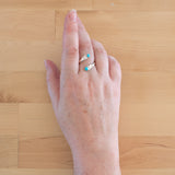 Hand of woman wearing the Turquoise and Sterling Silver Adjustable Ring with Two Stones